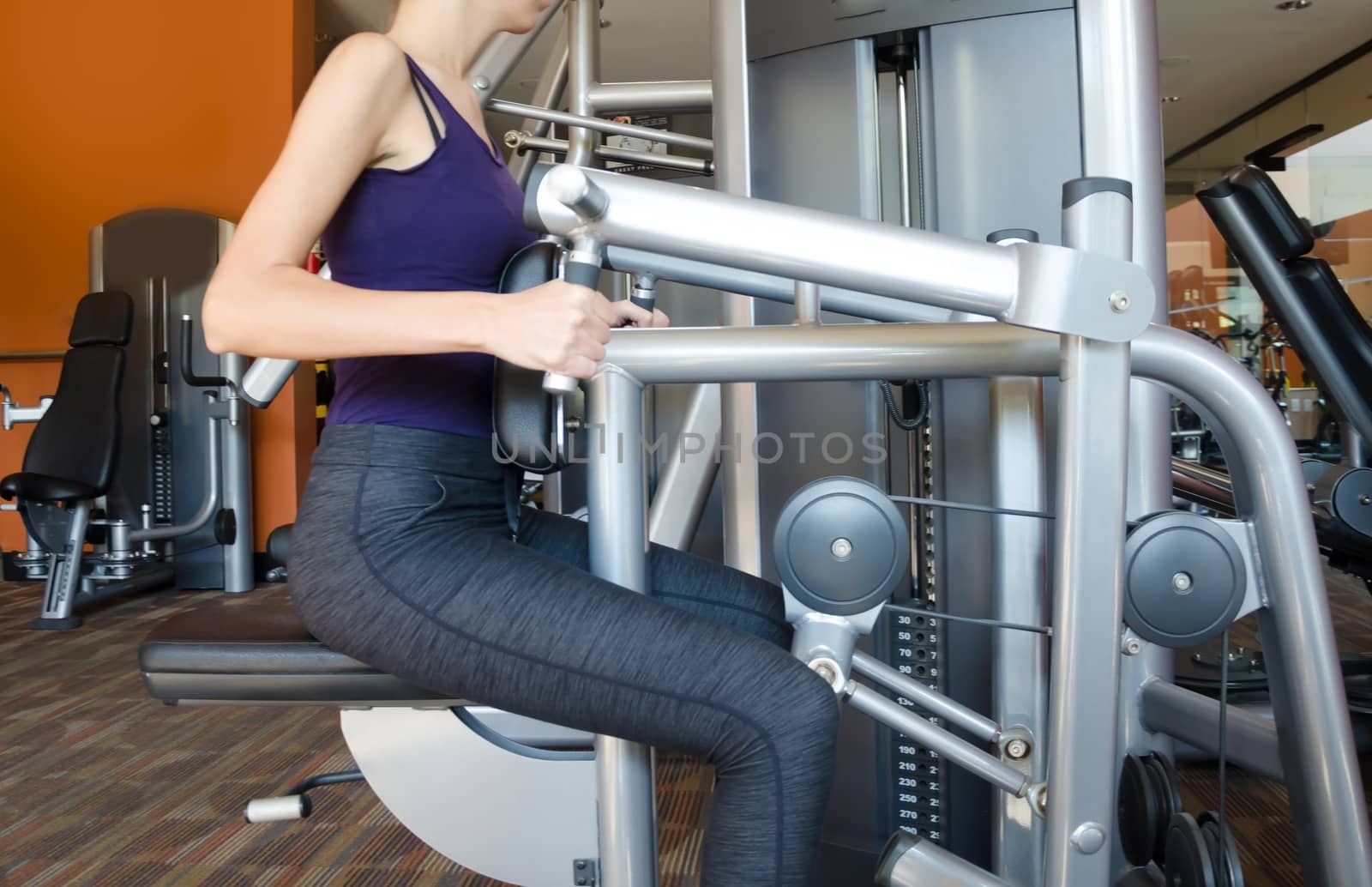 Girl training in gym on sport machine