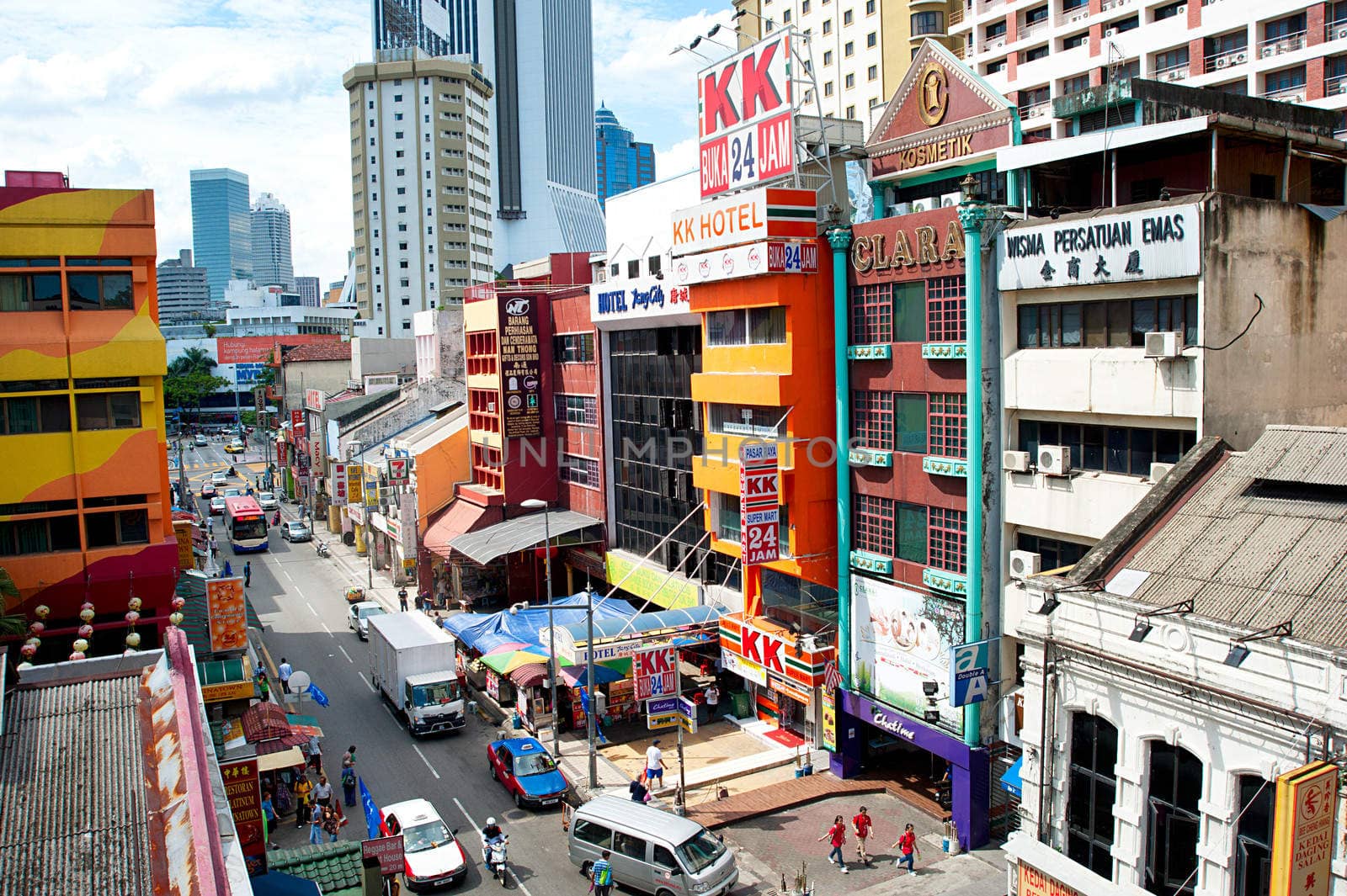 Kuala Lumpur, Malaysia -  May 11, 2013: People walking on Chinatown street in Kuala Lumpur. KL is the capital and most populous city in Malaysia. Covers an area of 243 km2 and has population of 1.6 million in 2012