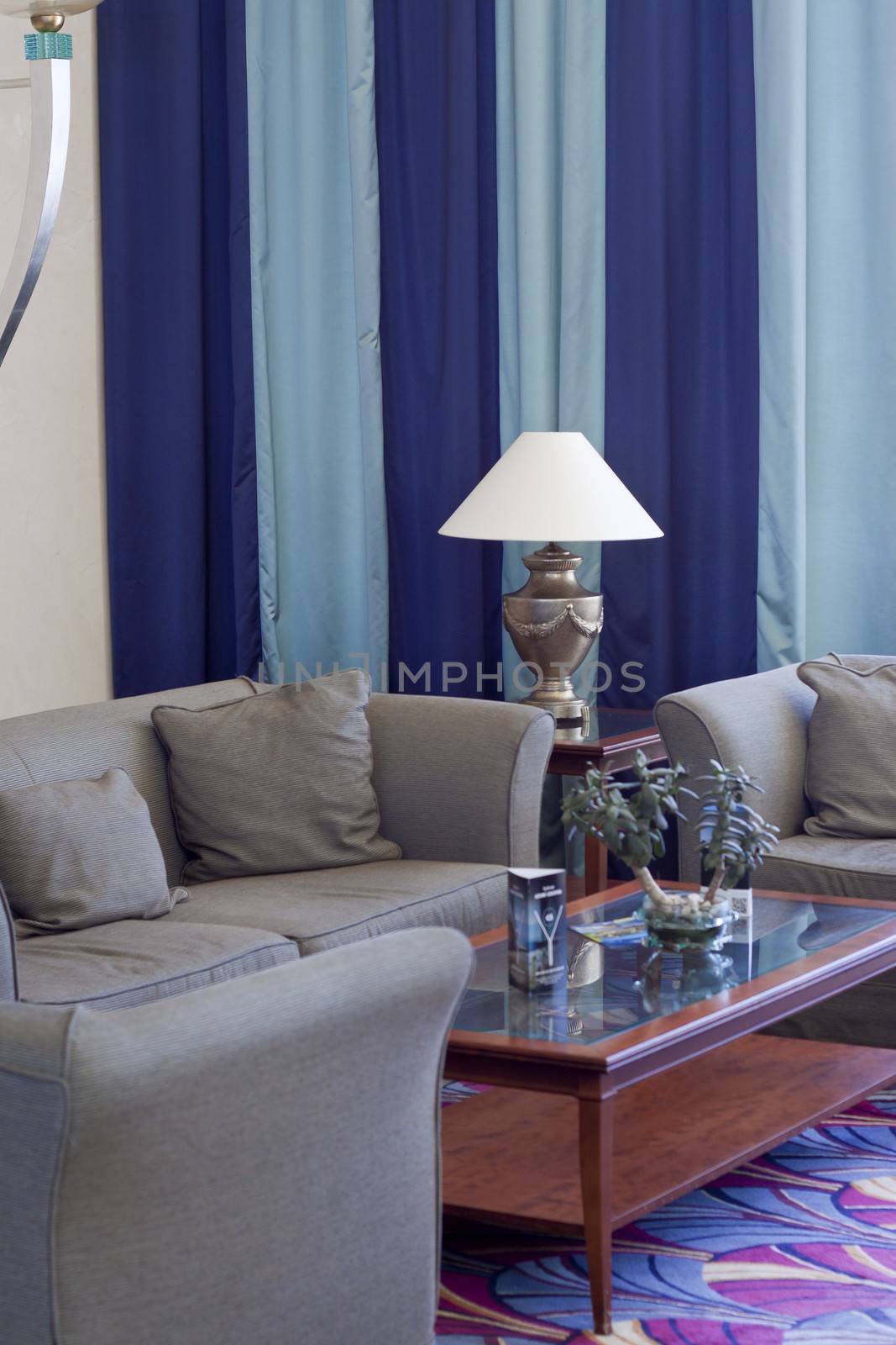 Detail of a living room with lamp sofa and table