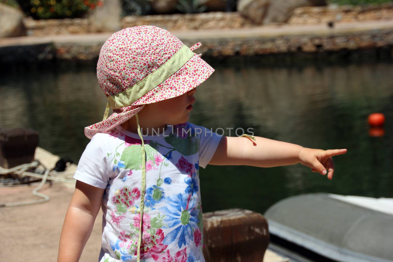 Portrait of little cute blond girl (one year and seven months of age) on the beach