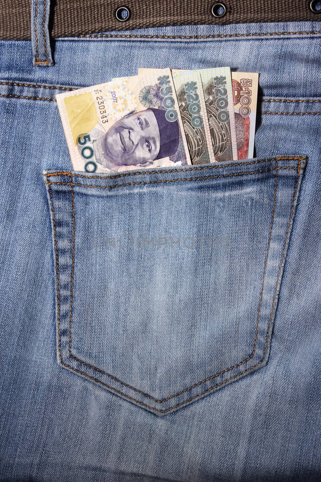 closeup of striped male jeans with nairas in a pocket