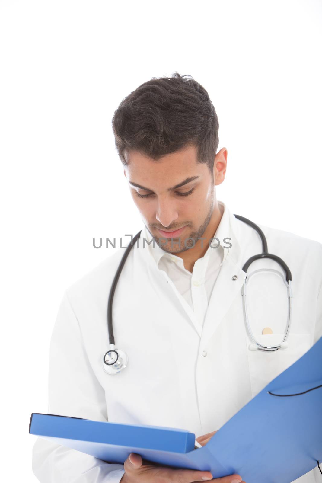 Handsome young male doctor standing reading a patients records in a large blue folder as he conducts his ward rounds