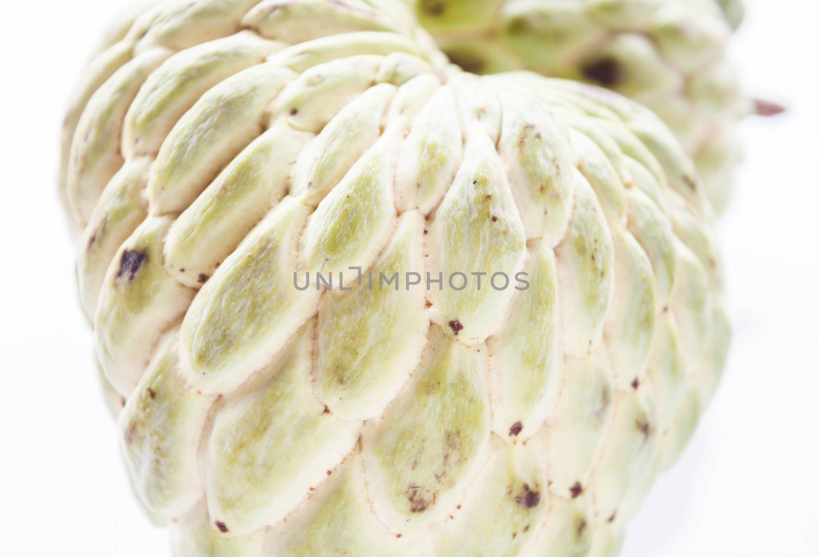 Close up peel texture of unripe custard apple  by punsayaporn
