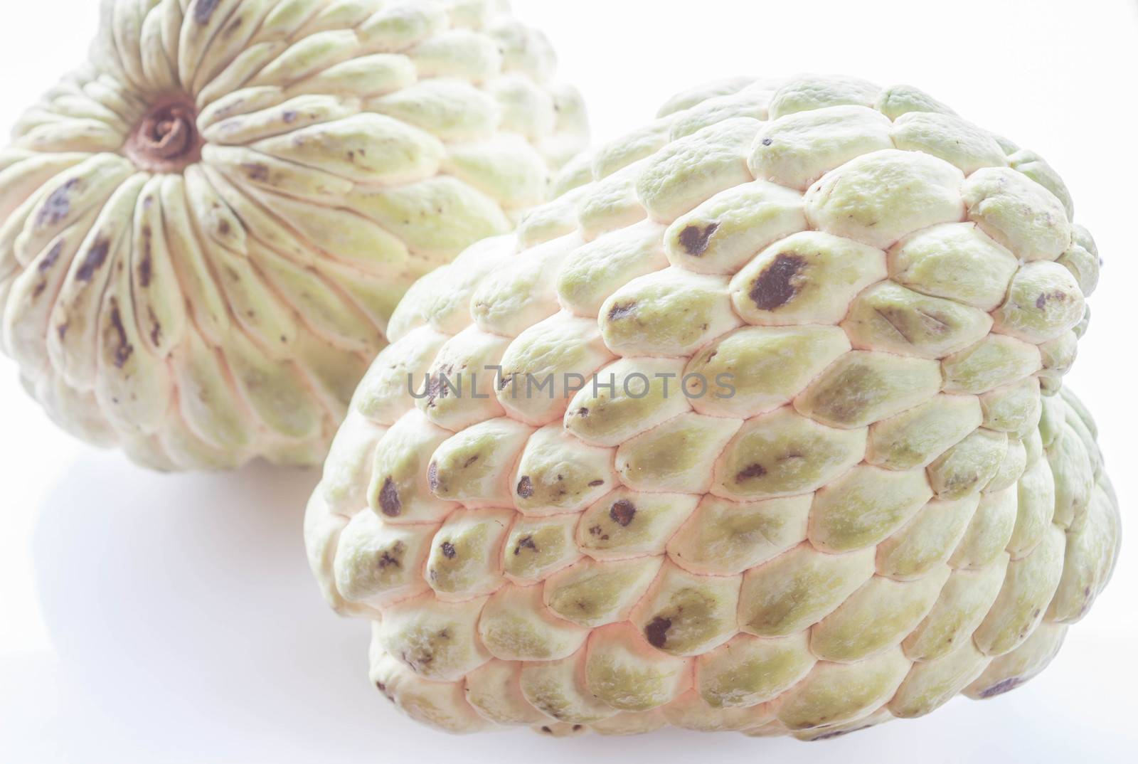 Couple unripe sugar apple isolated on white background by punsayaporn