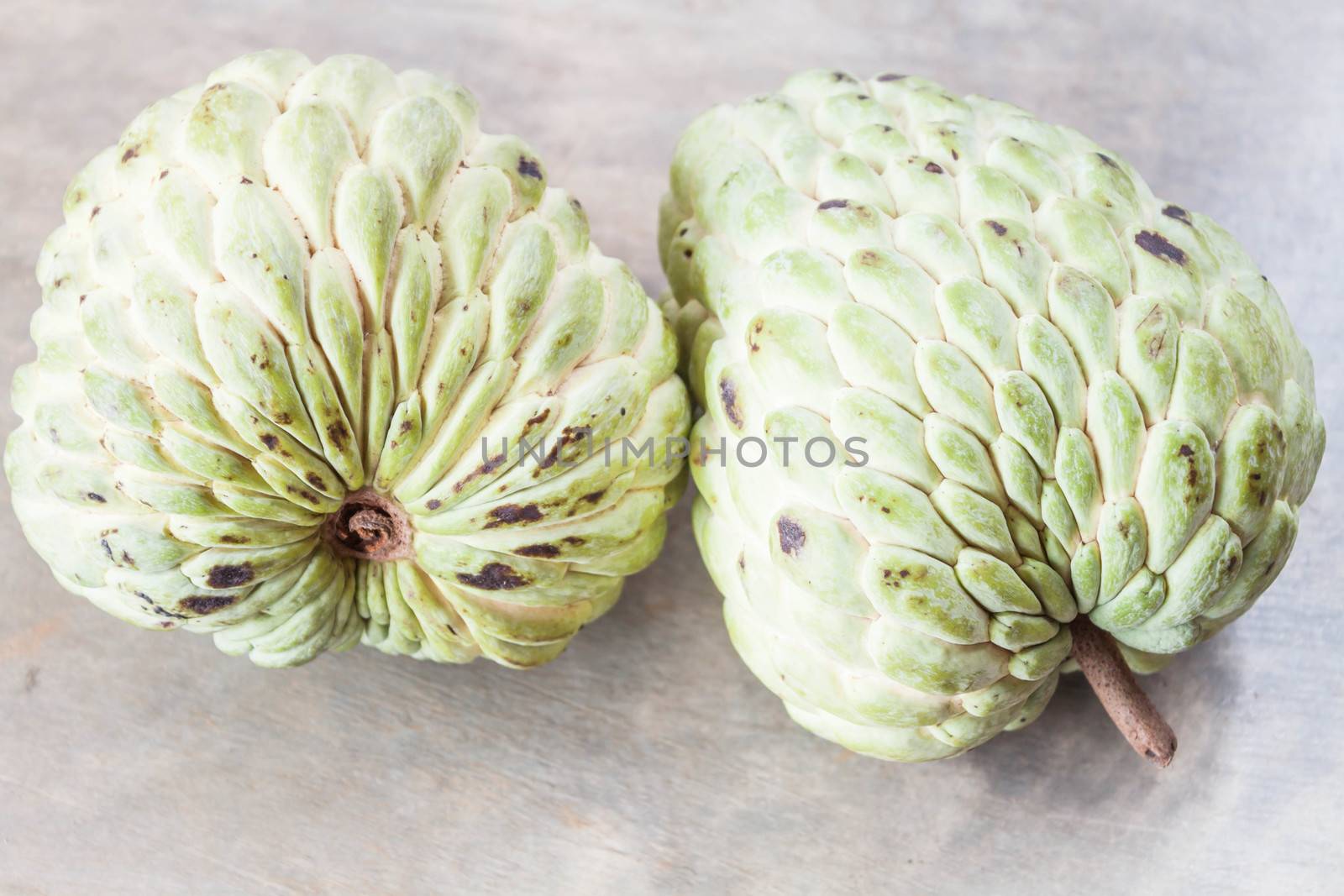 Couple fresh custard apple on gray background