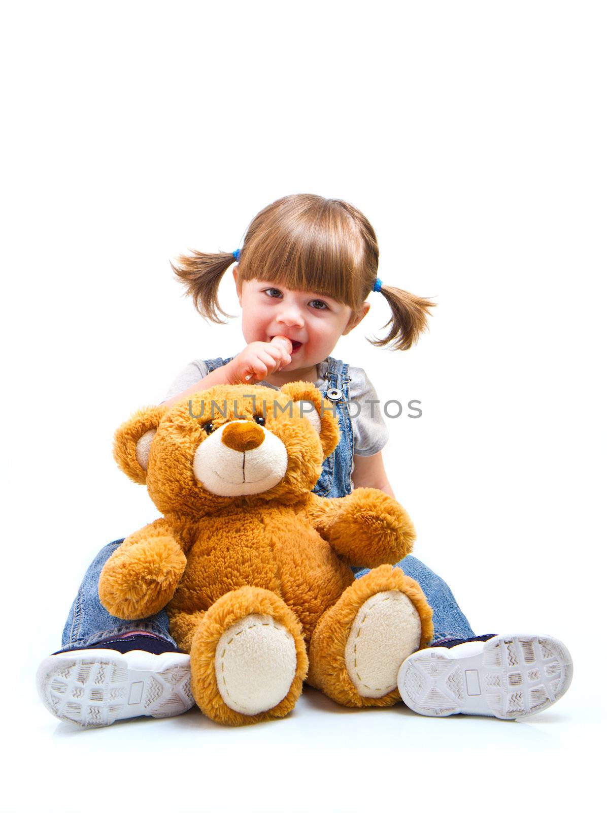 adorable toddler girl hugging a teddy bear