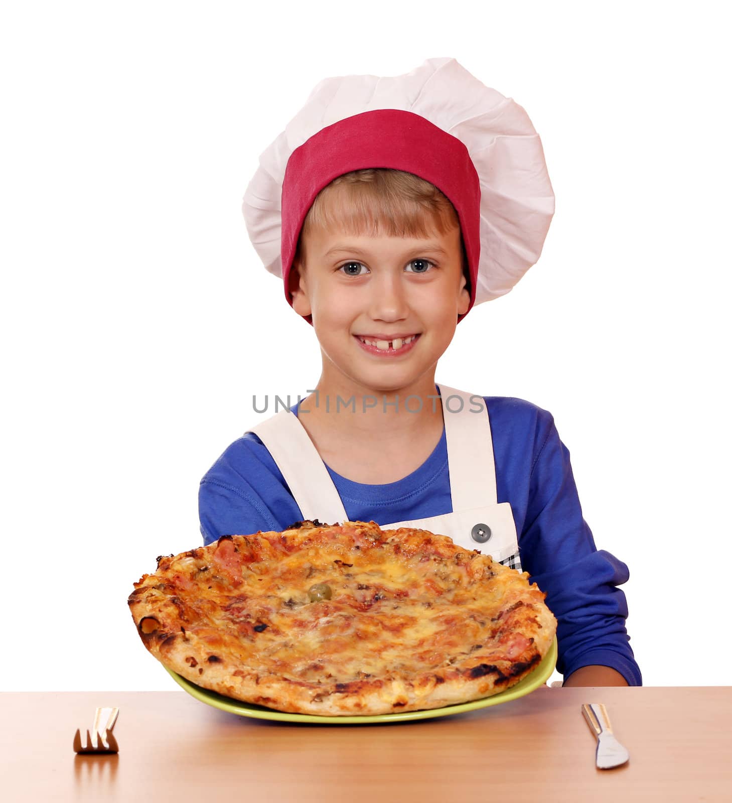happy boy chef hold pizza on table by goce