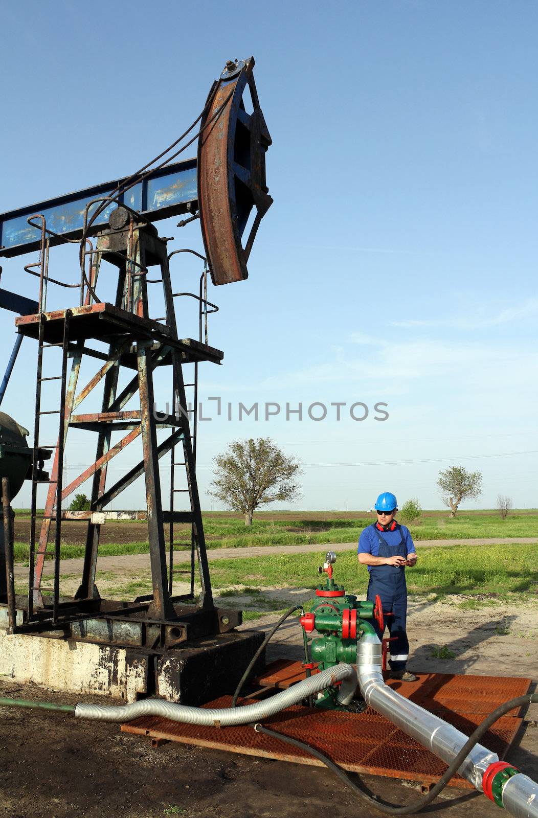 oil worker with tablet pc check pipeline by goce