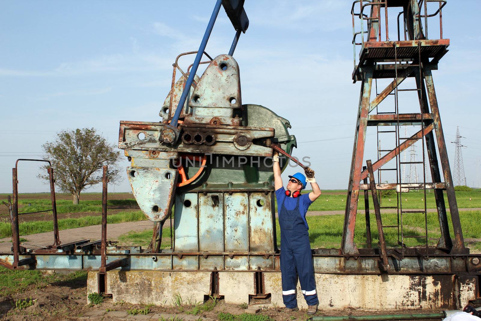 oil worker working on oilfield by goce