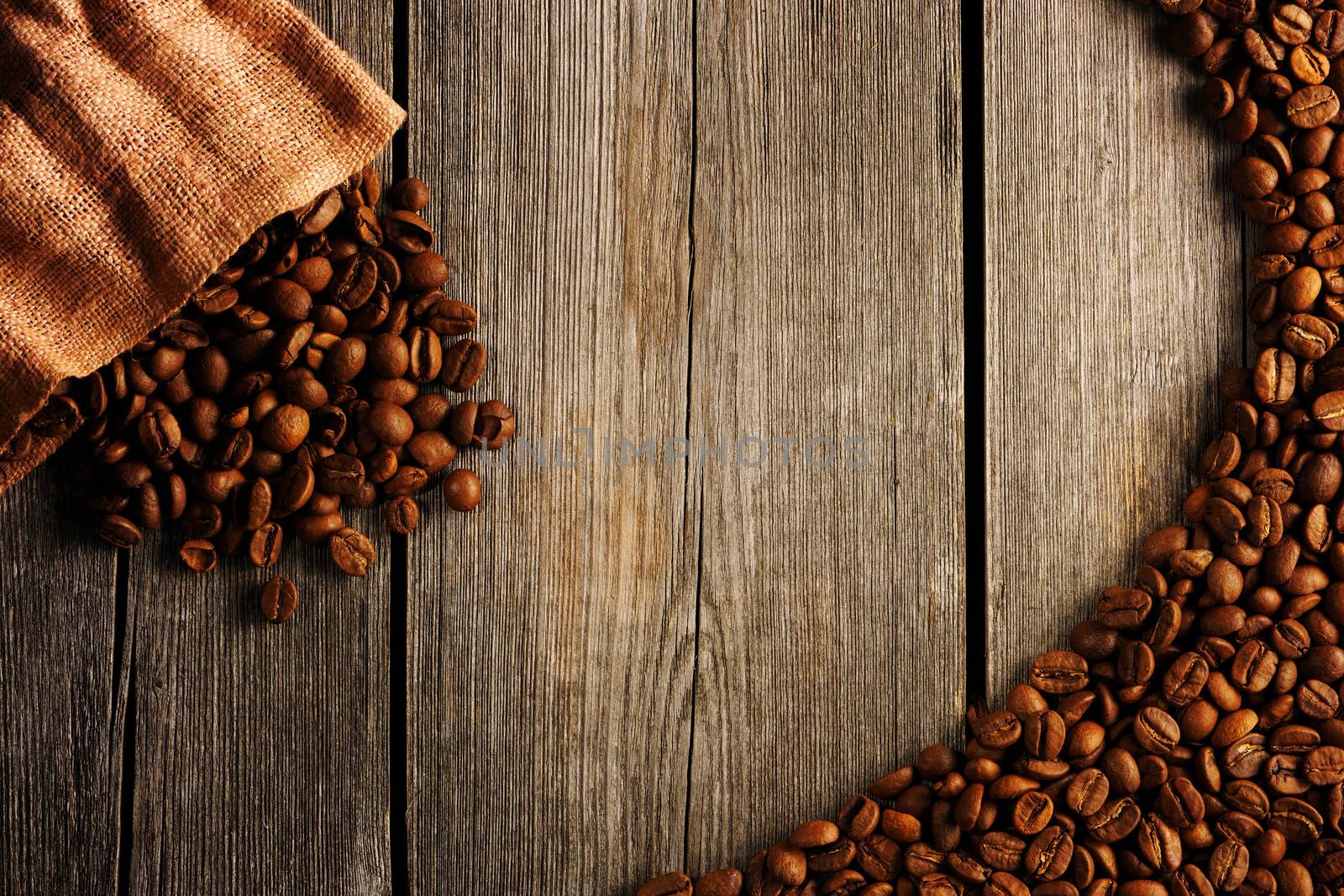 Coffee beans and bag over wooden background