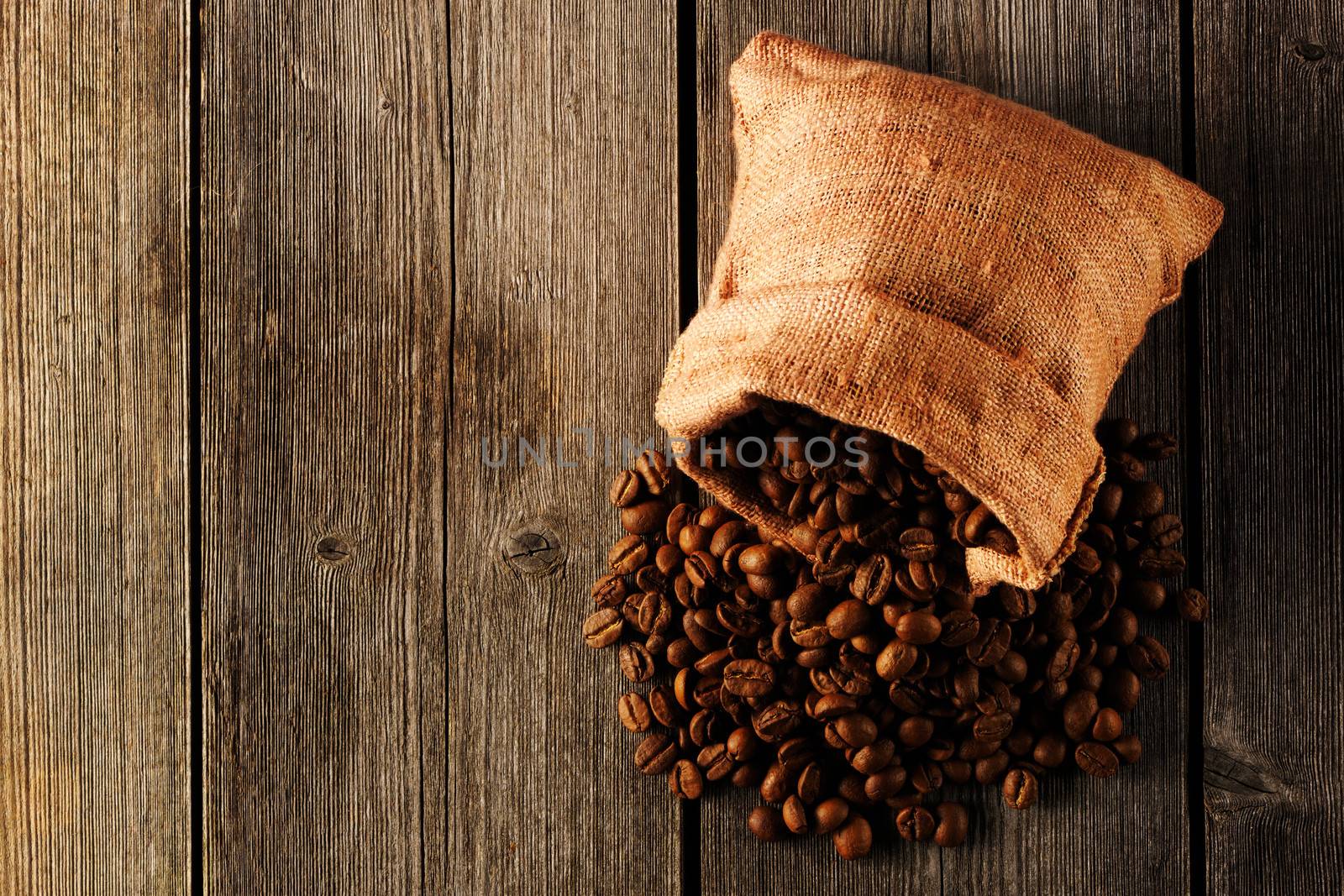 Coffee beans in bag on wooden table