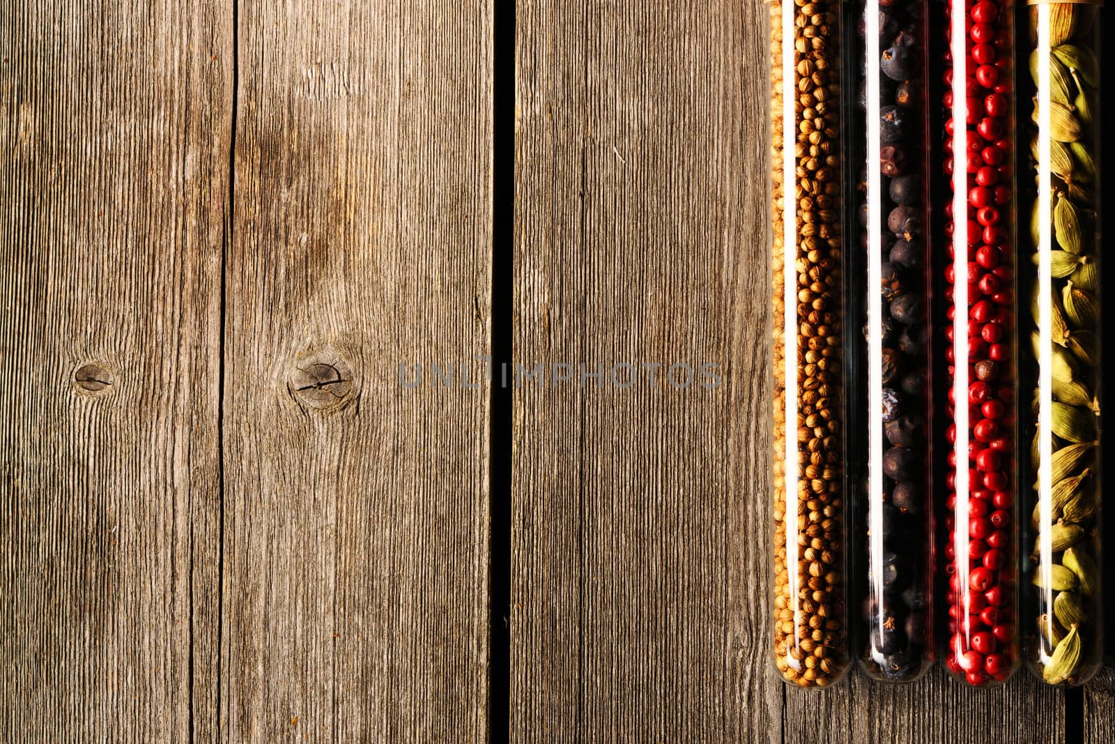 Spices in beakers on wooden background