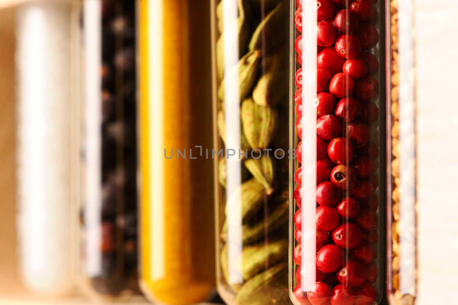 Spices in beakers against dark background