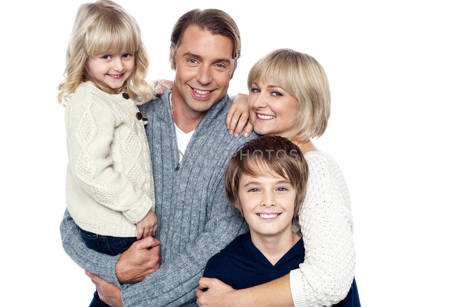 A happy family with children in studio by stockyimages