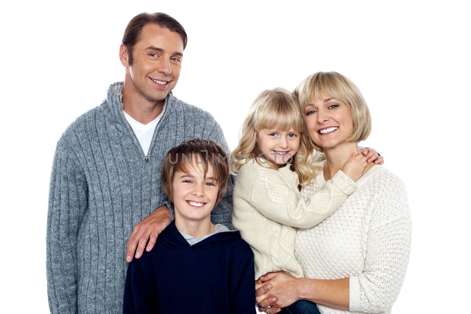 Portrait of friendly family of four in the studio by stockyimages