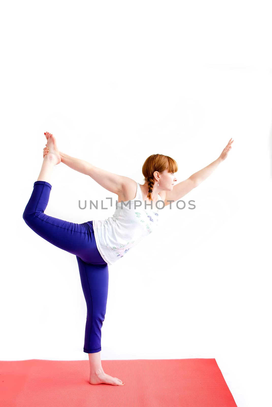 middle aged redhead woman exercising yoga isolated on white