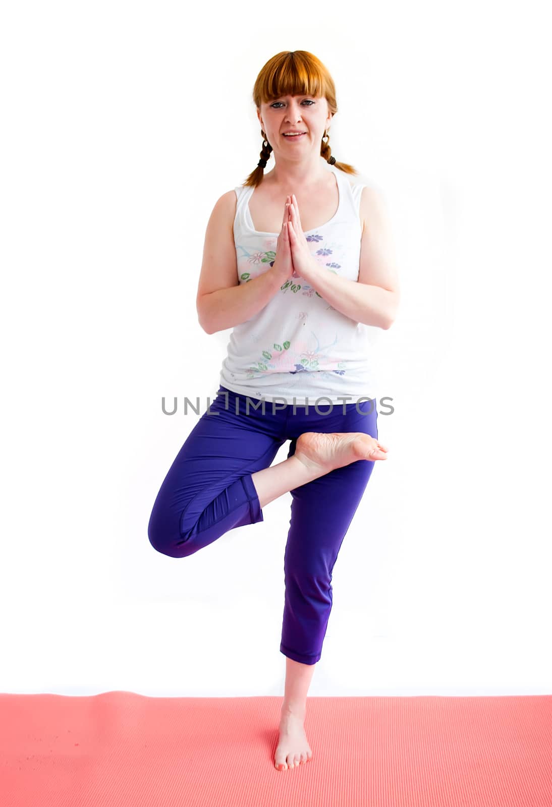 middle aged redhead woman exercising yoga isolated on white