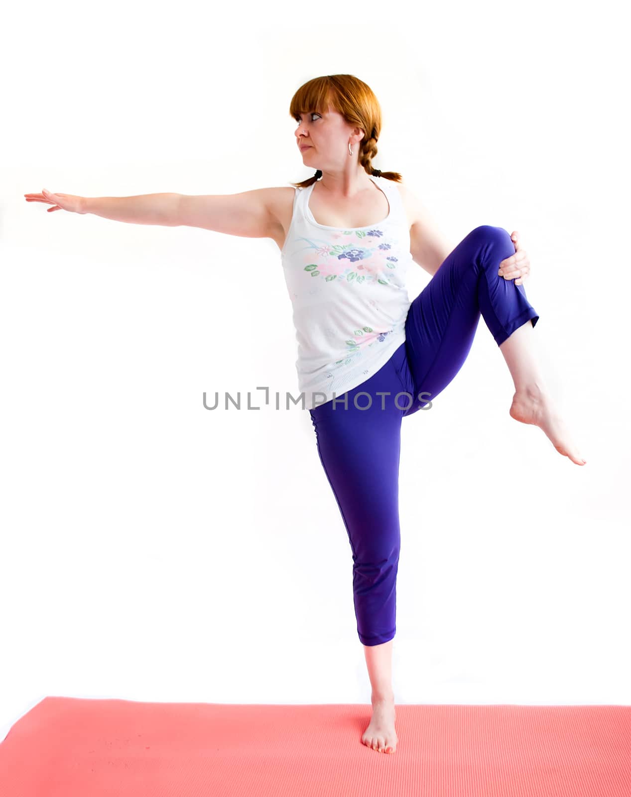 middle aged redhead woman exercising yoga isolated on white