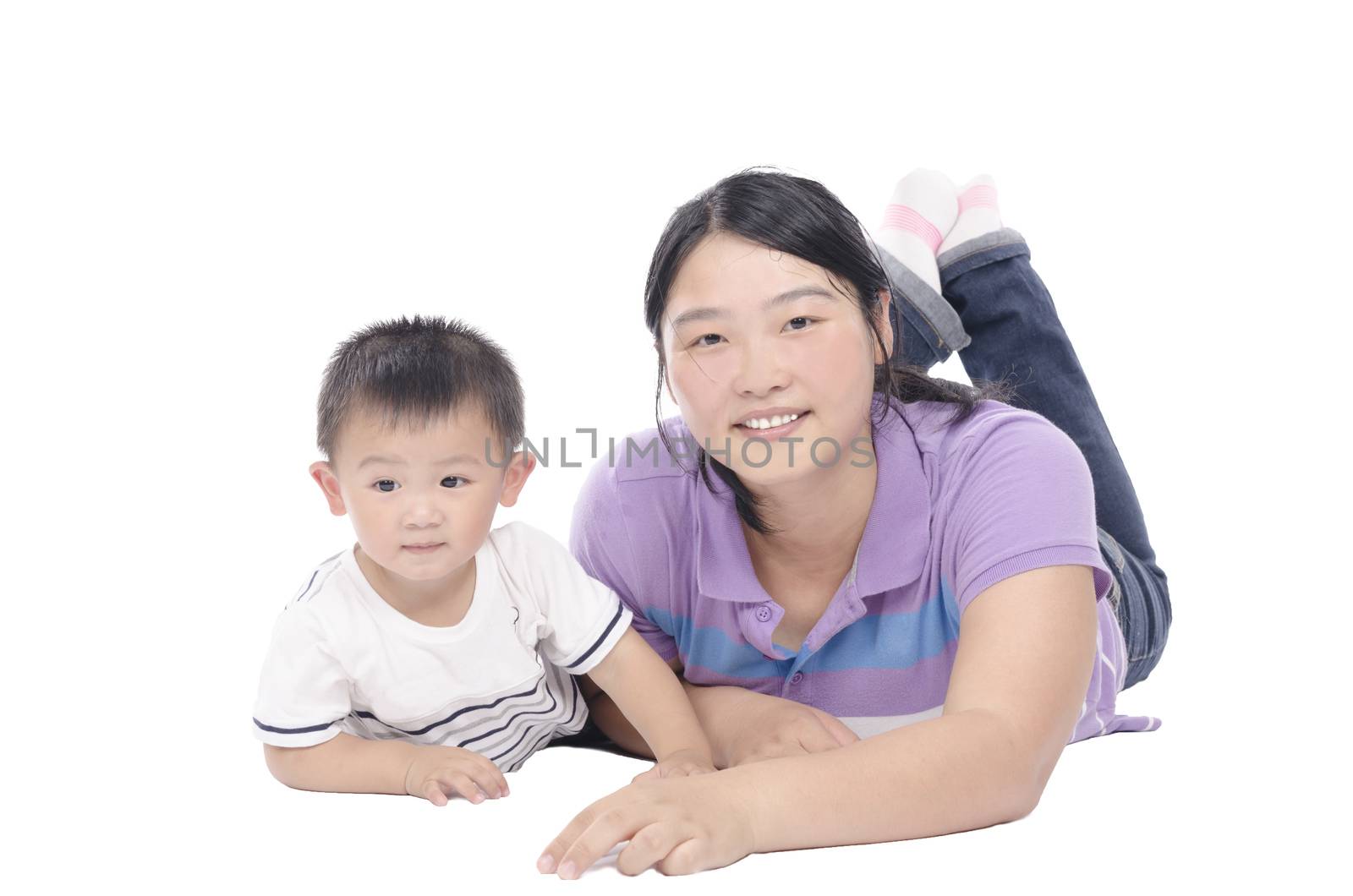 Happy mother and child lying on floor