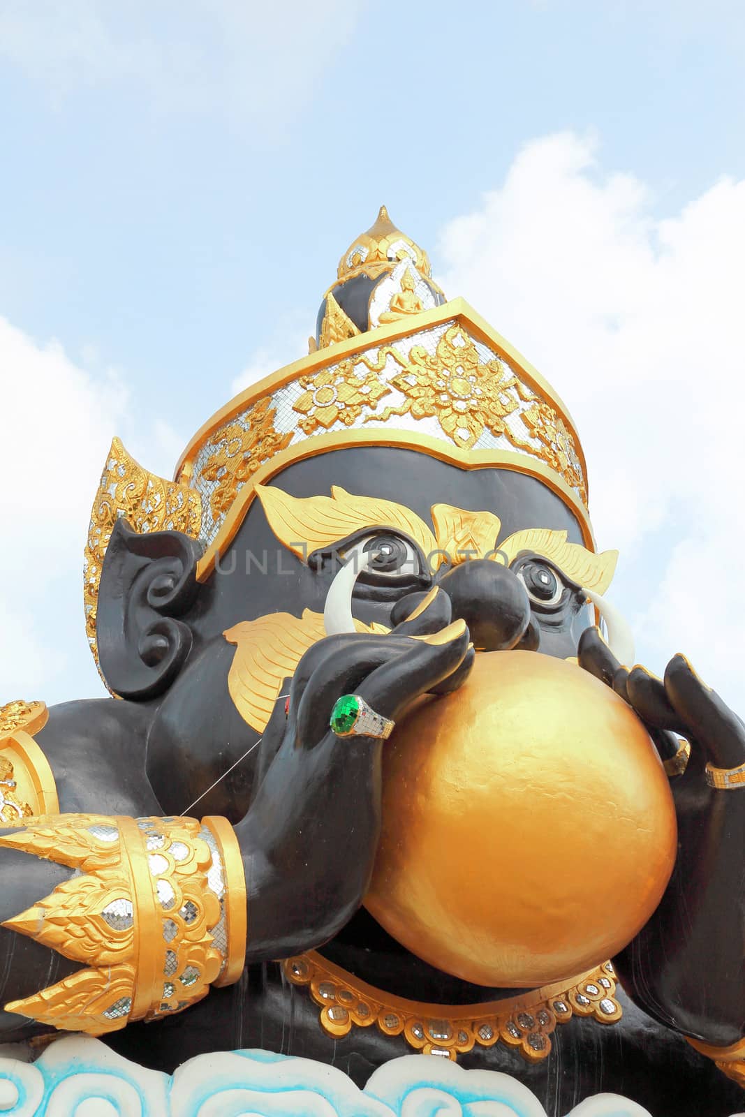 Rahu (god of darkness) statue with blue sky