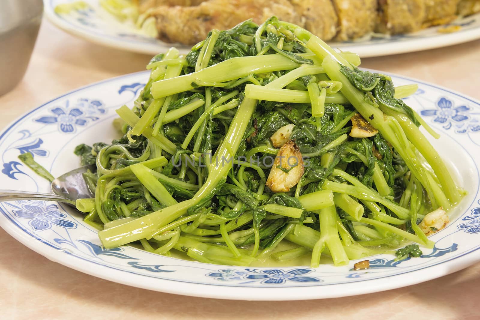 Stir Fry Chinese Kangkong Green Vegetable with Garlic Dish Closeup