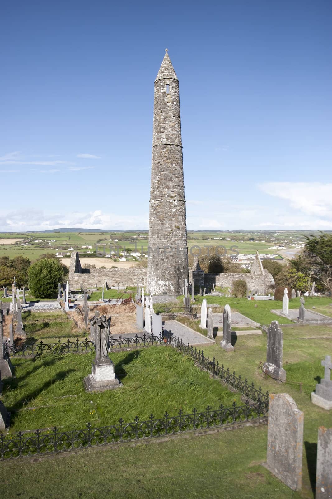 Ancient round tower and celtic graveyard with cathedral in Ardmore county Waterford, Ireland