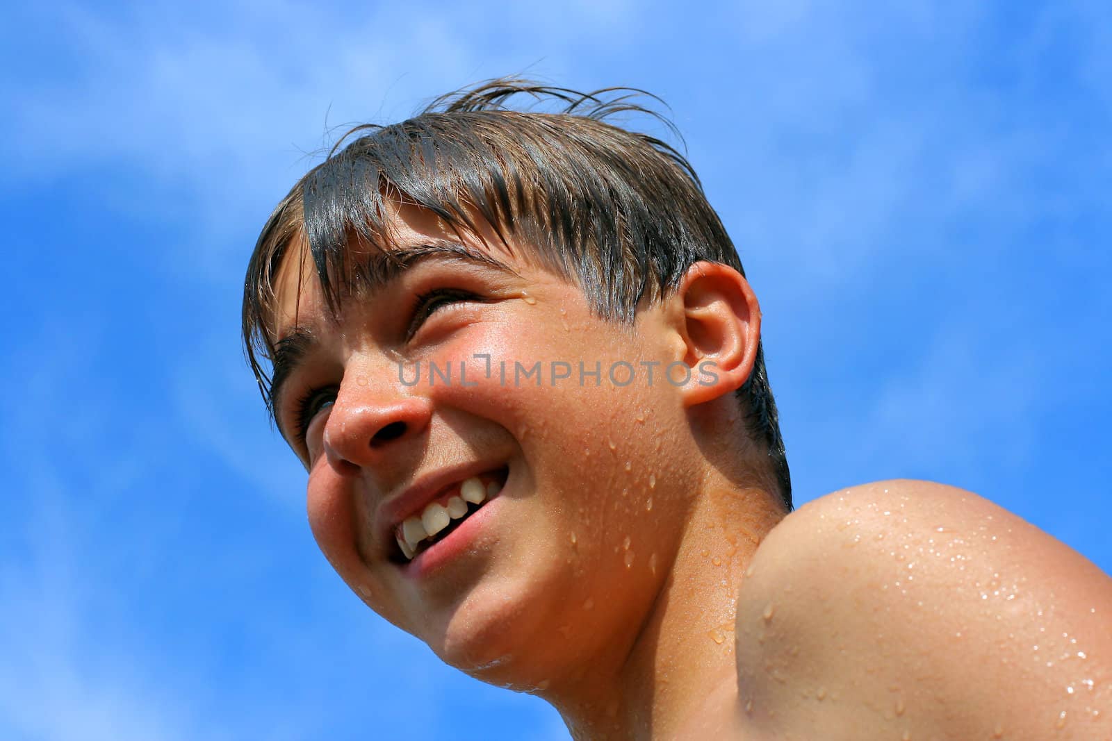 Cheerful boy loooks happy in the summertime