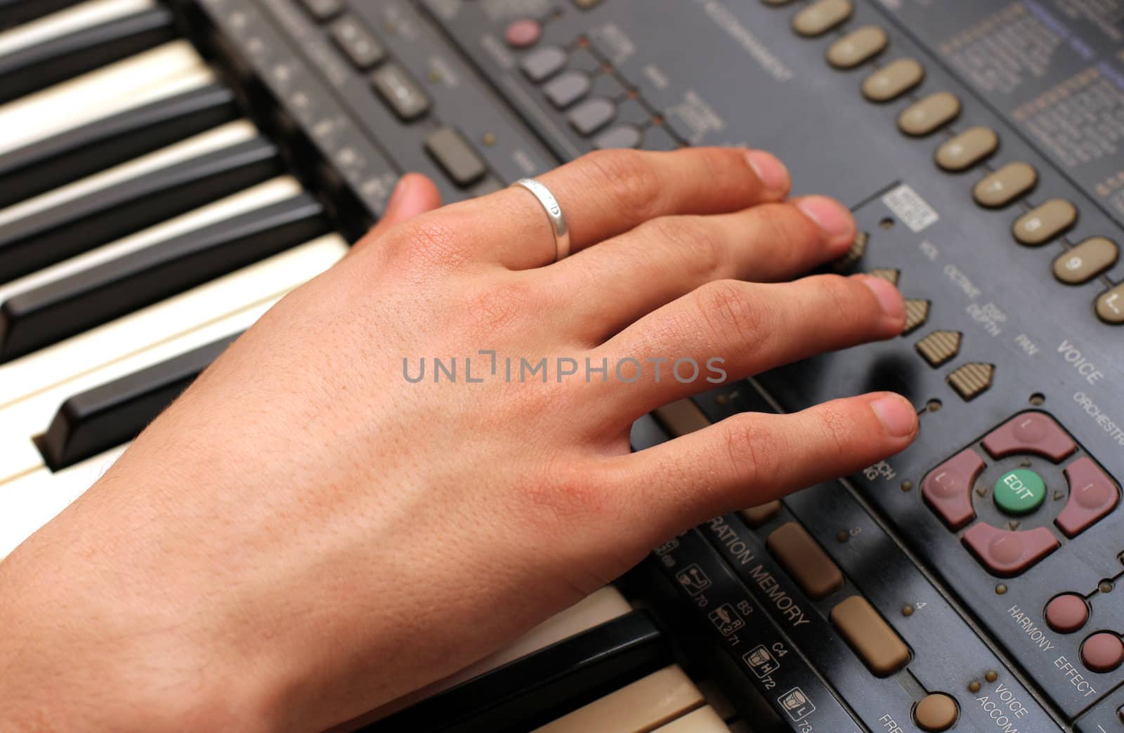 hand on the keyboard synthesizer