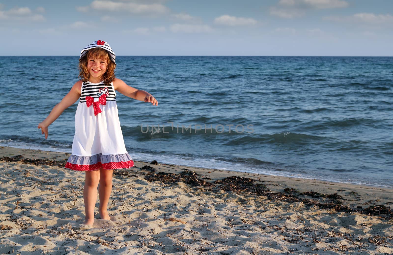 beautiful little girl on beach by goce