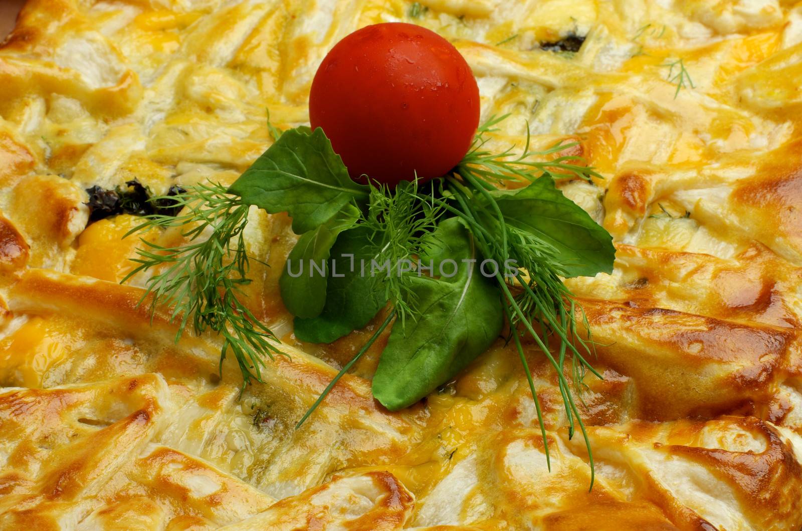 Background of Cheese and Greens Puff Pastry Pie with Cherry Tomato closeup