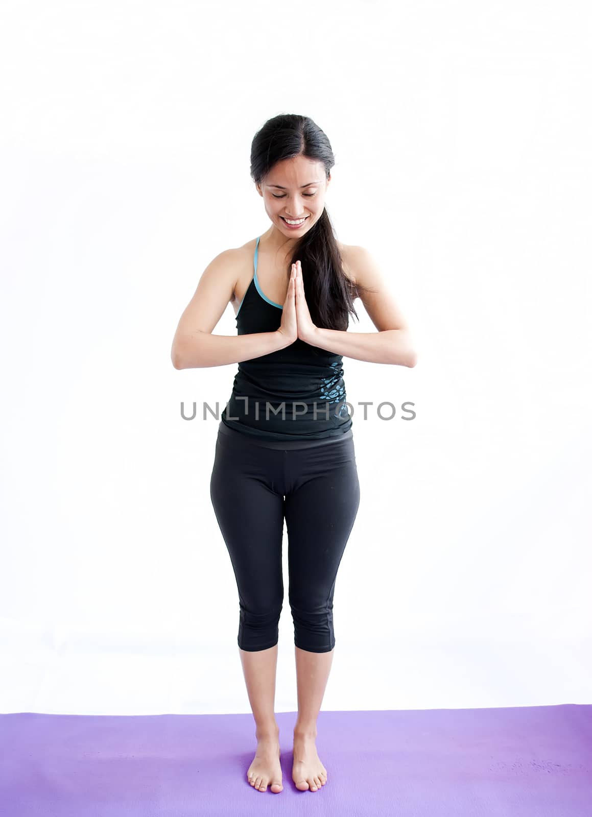 young brunette girl practising yoga isolated on white