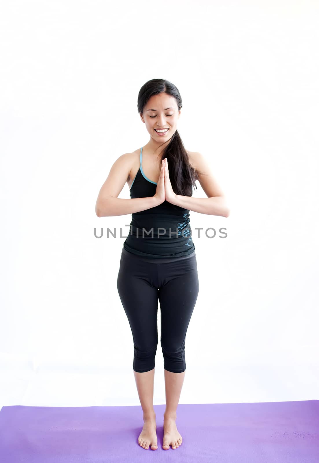 young brunette girl practising yoga isolated on white