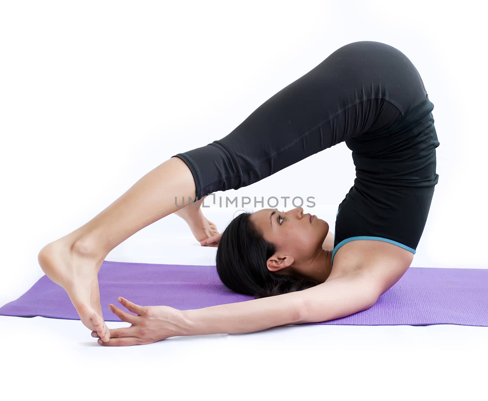 young brunette girl practising yoga isolated on white