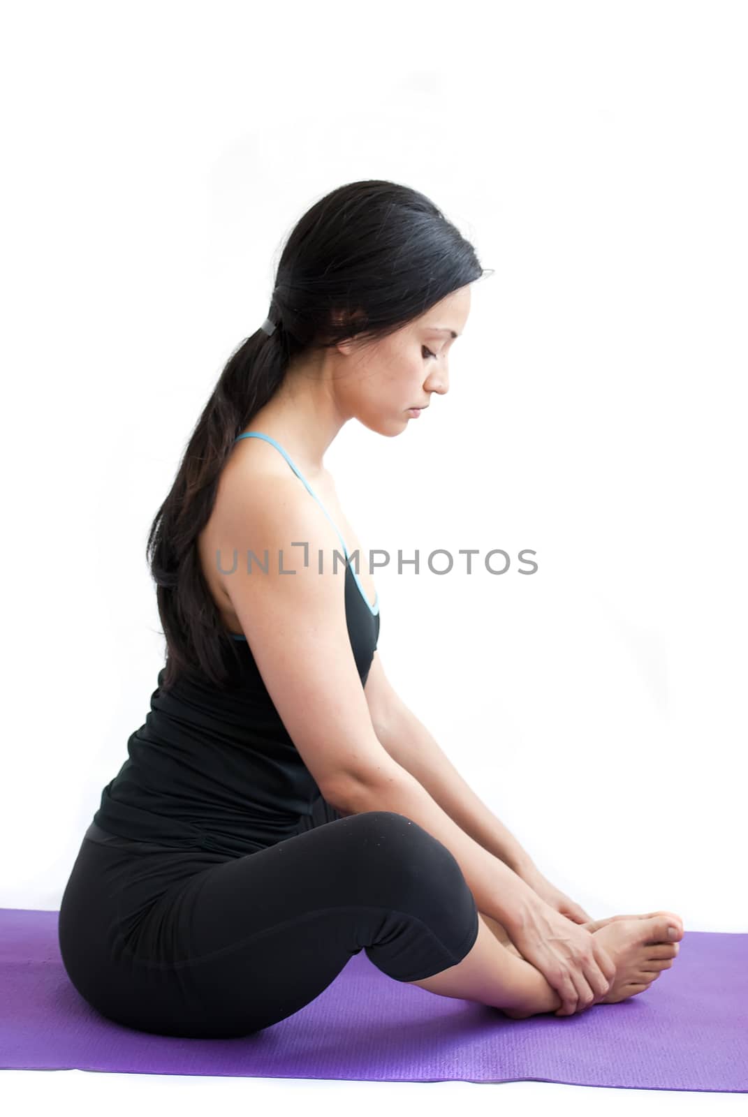 young brunette girl practising yoga isolated on white