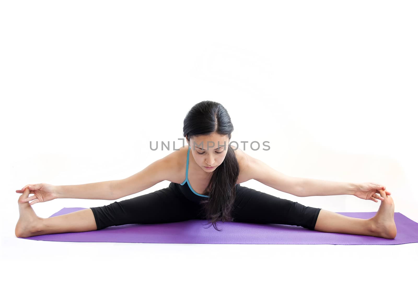 young brunette girl practising yoga isolated on white