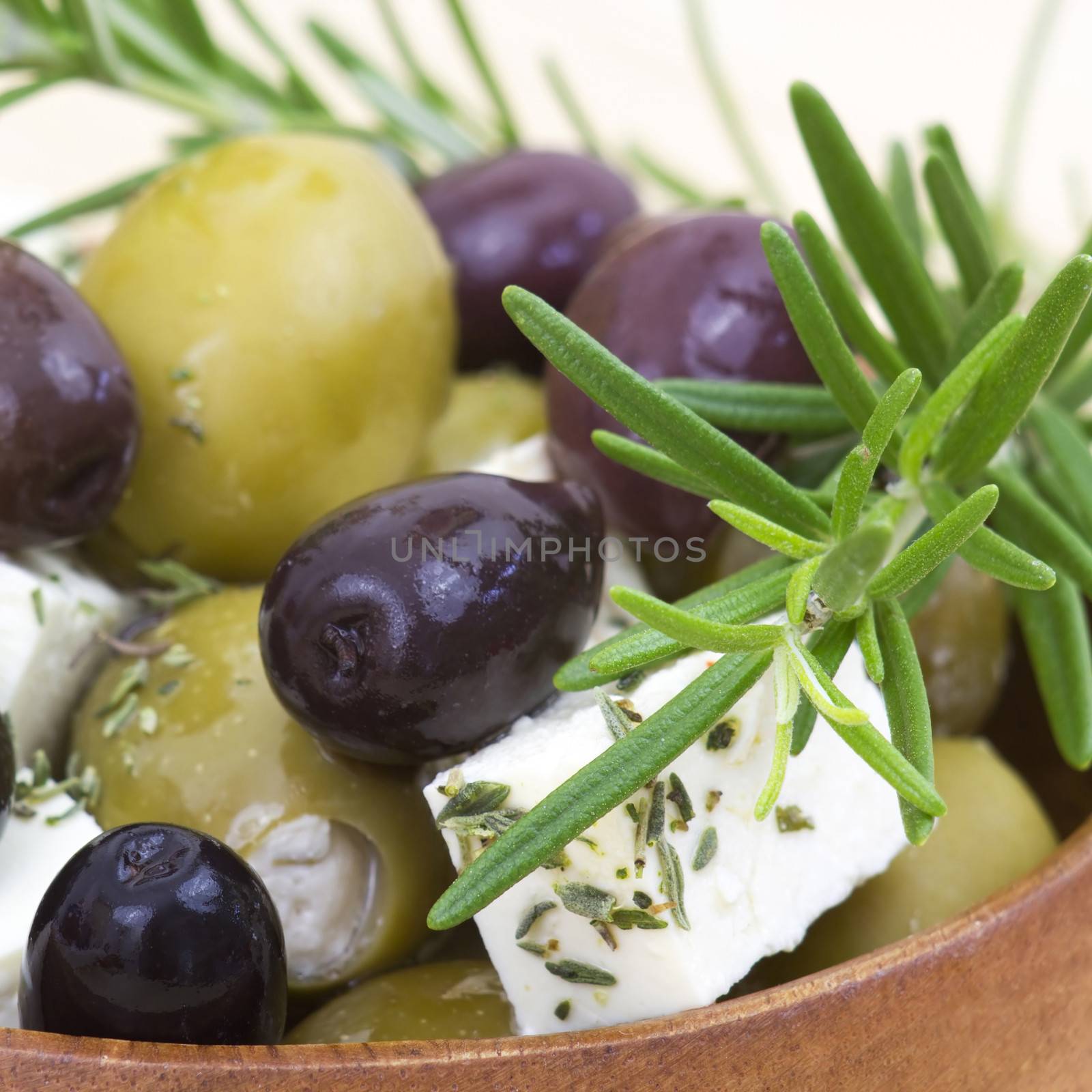 feta cheese and olives with herbs in olive oil by miradrozdowski