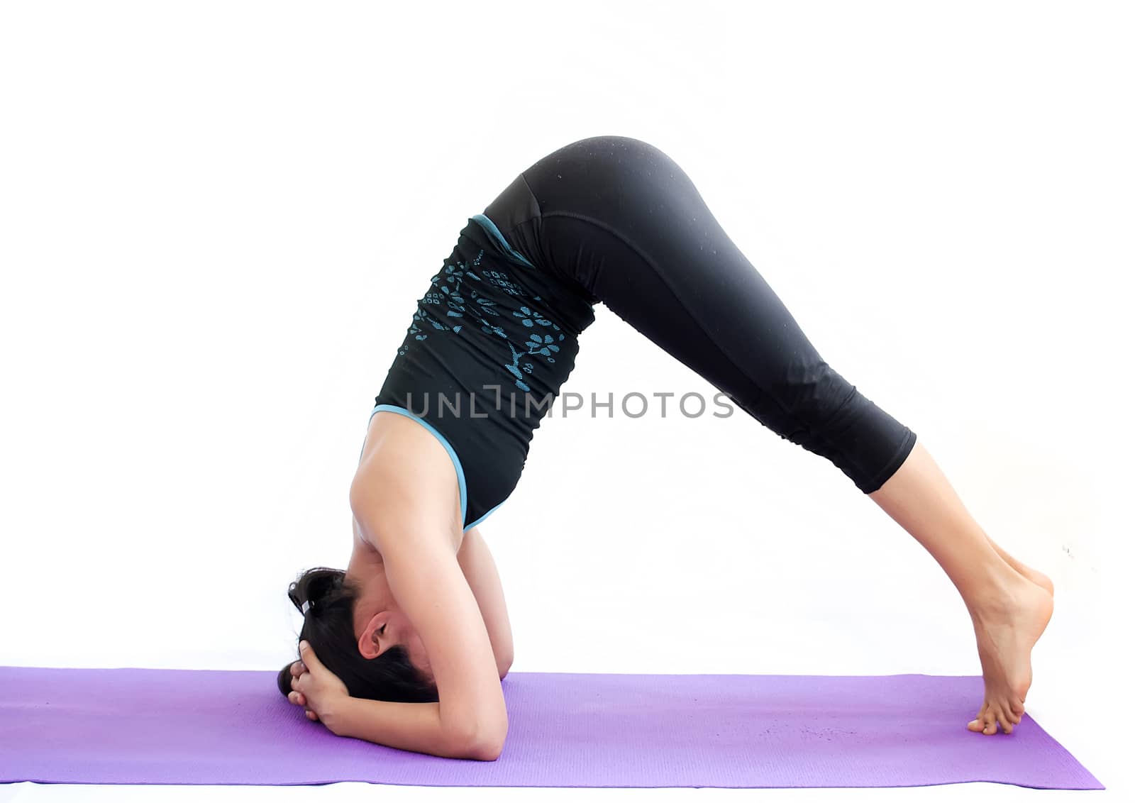 young brunette girl practising yoga isolated on white