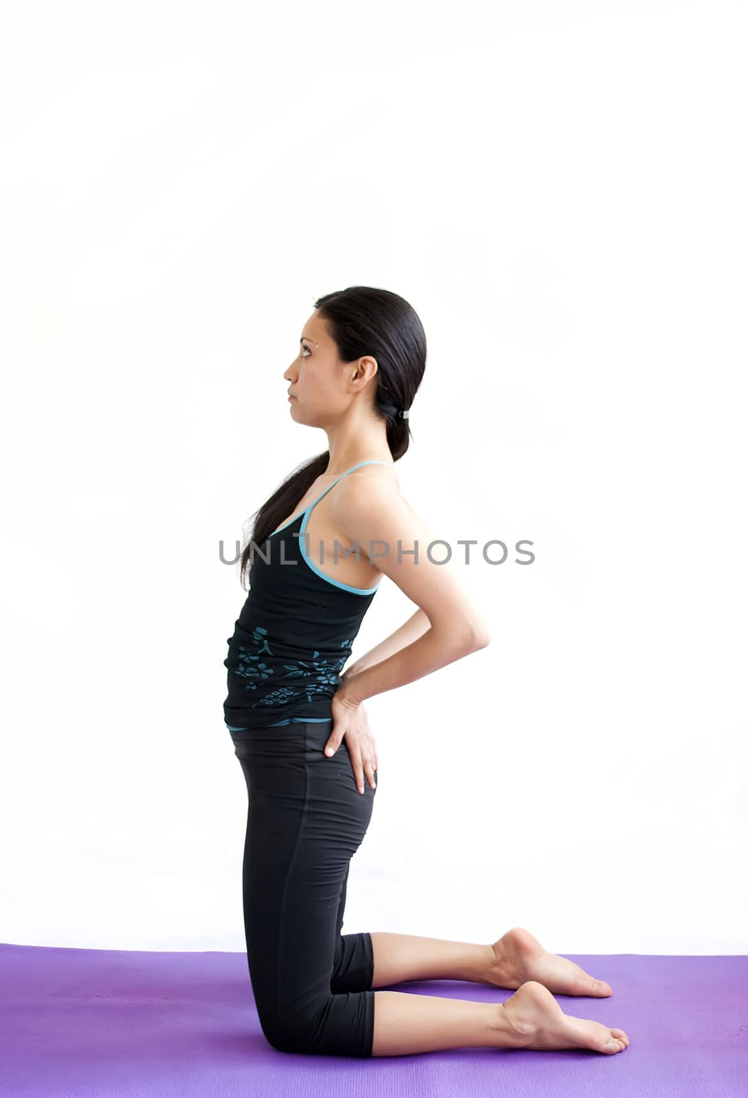 young brunette girl practising yoga isolated on white