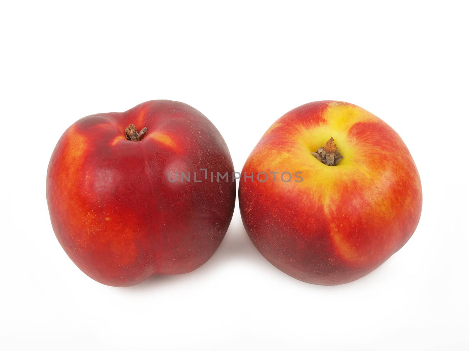 two fresh nectarines isolated on white background       