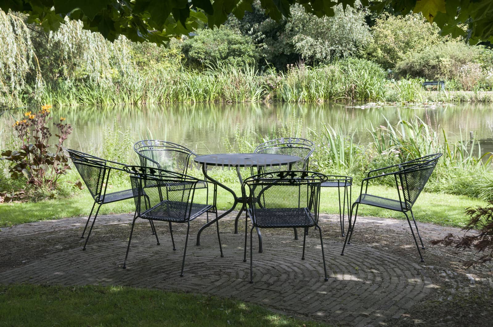 green park with metal chairs and table garden furniture