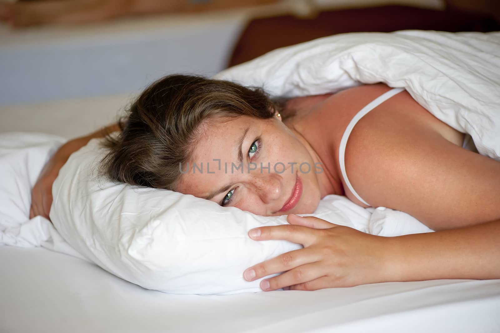 young girl luxuriating in bed the morning