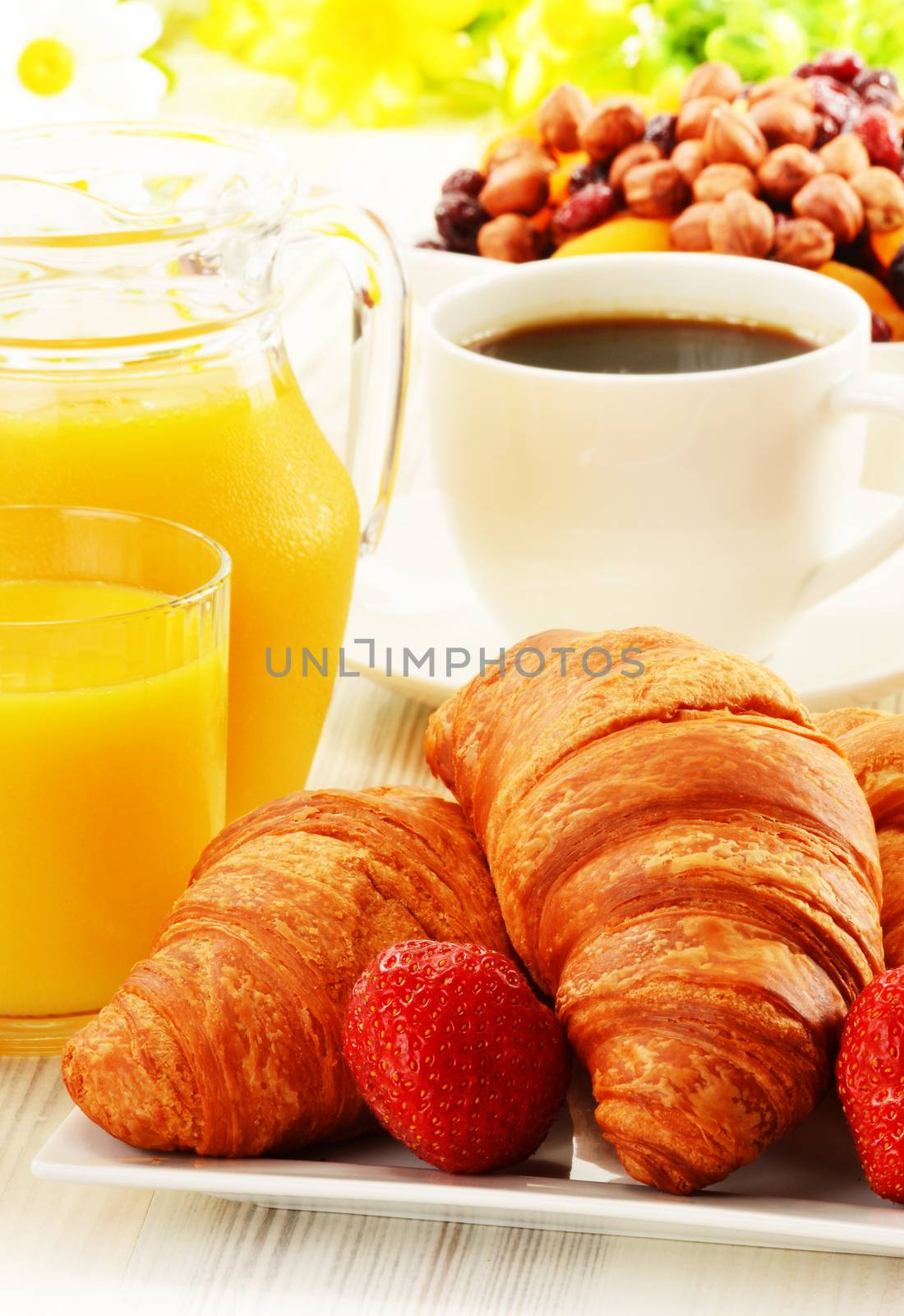 Breakfast with croissants, cup of coffee and fruits