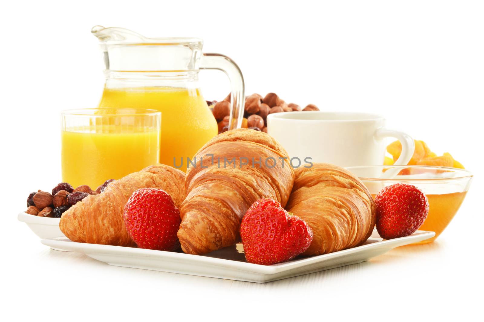 Breakfast with croissants, cup of coffee and fruits