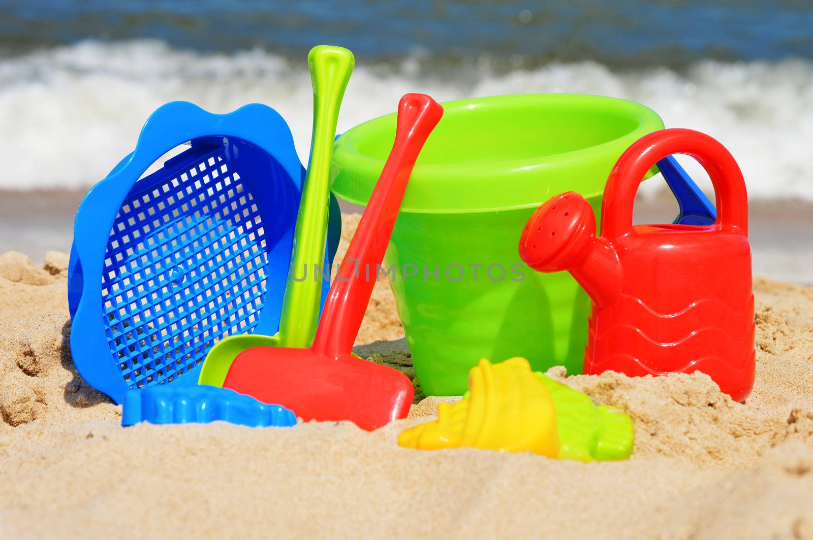 Plastic children toys on the sand beach