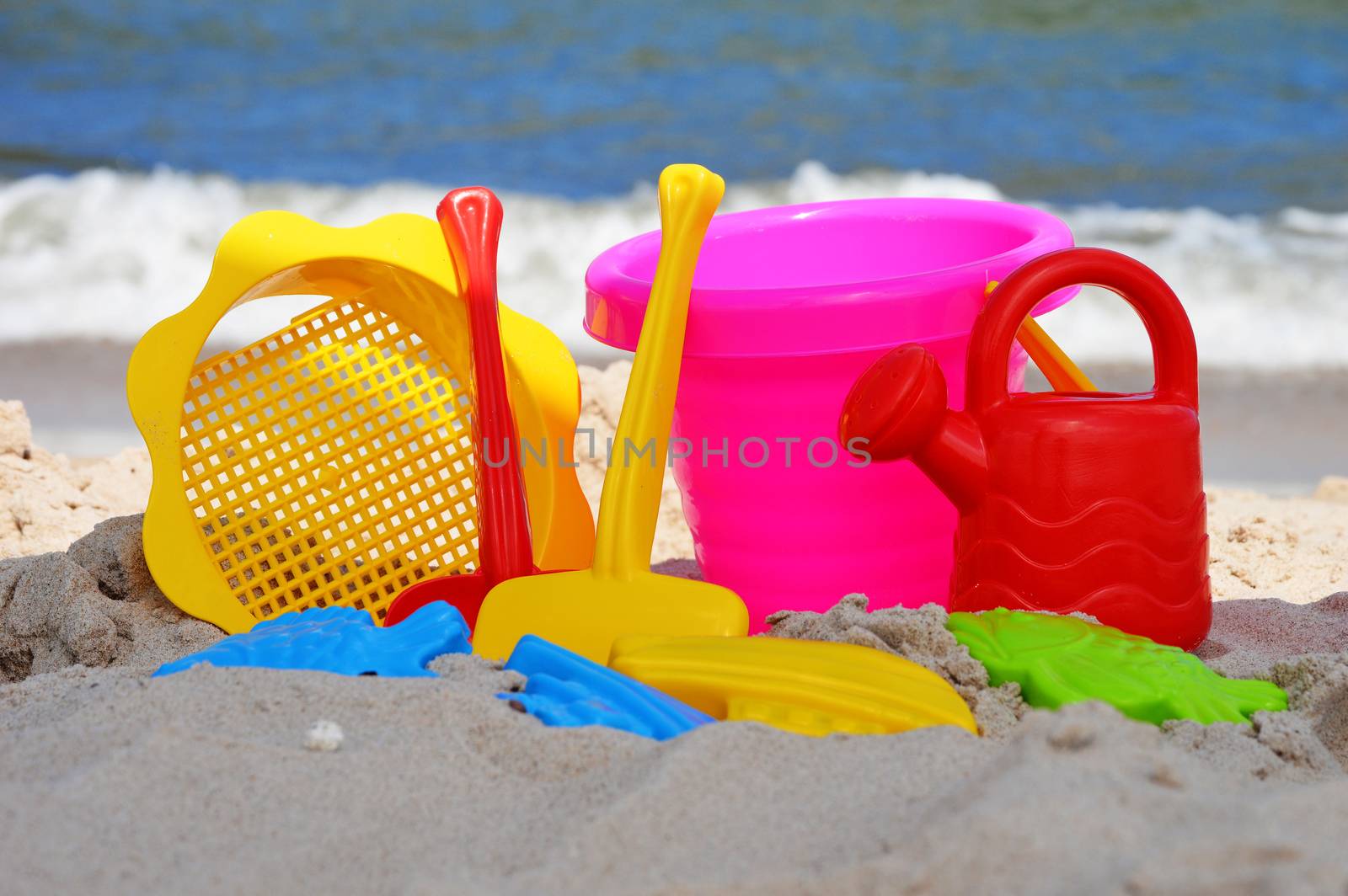 Plastic children toys on the sand beach