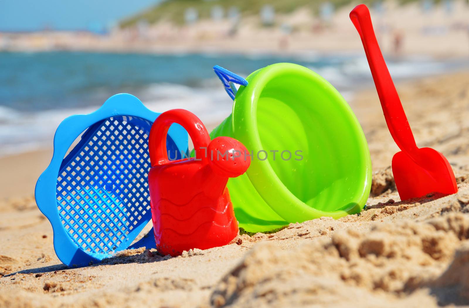 Plastic children toys on the sand beach