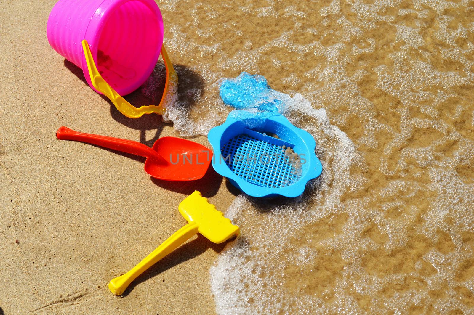 Plastic children toys on the sand beach