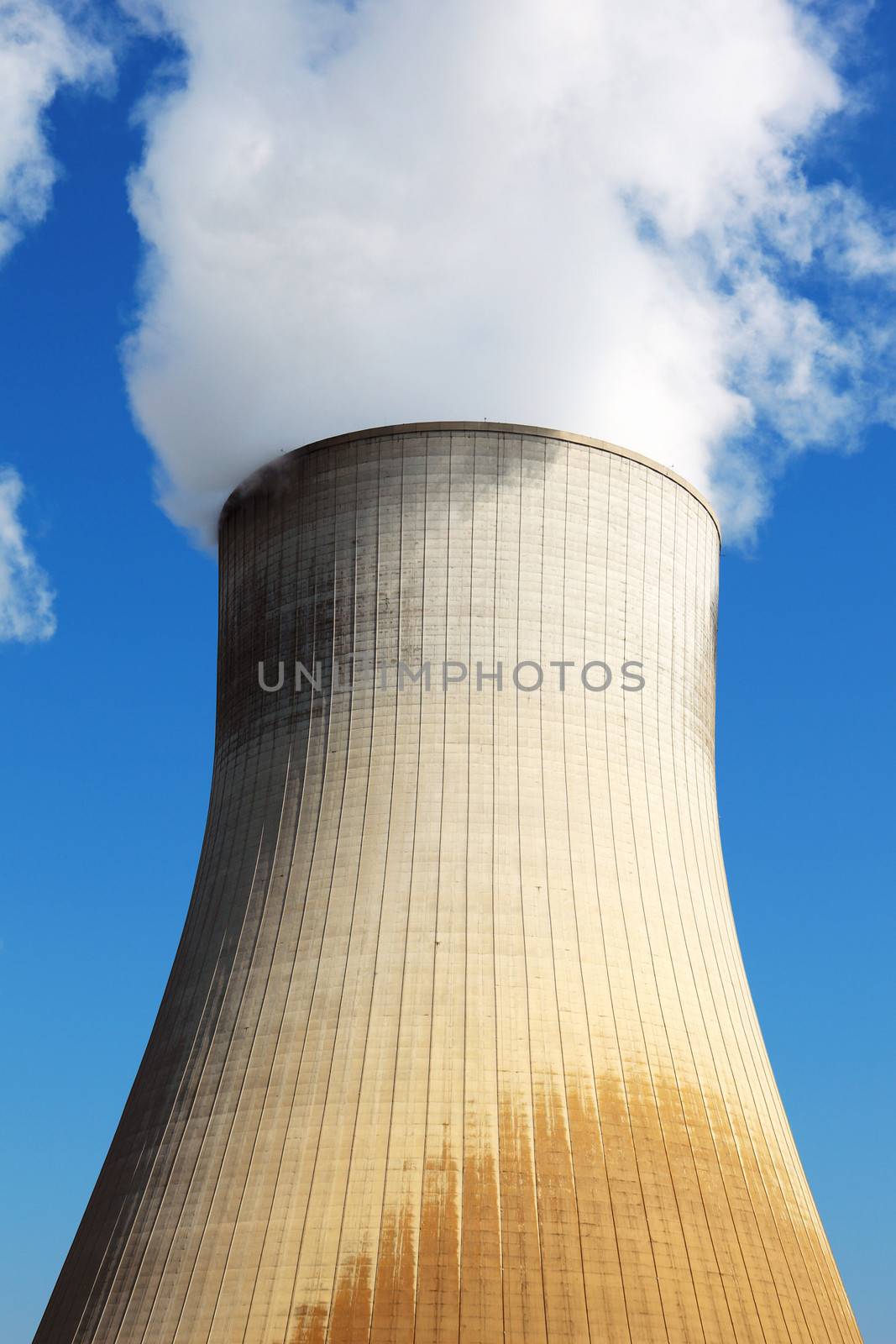 Nuclear power station cooling tower in blue sky