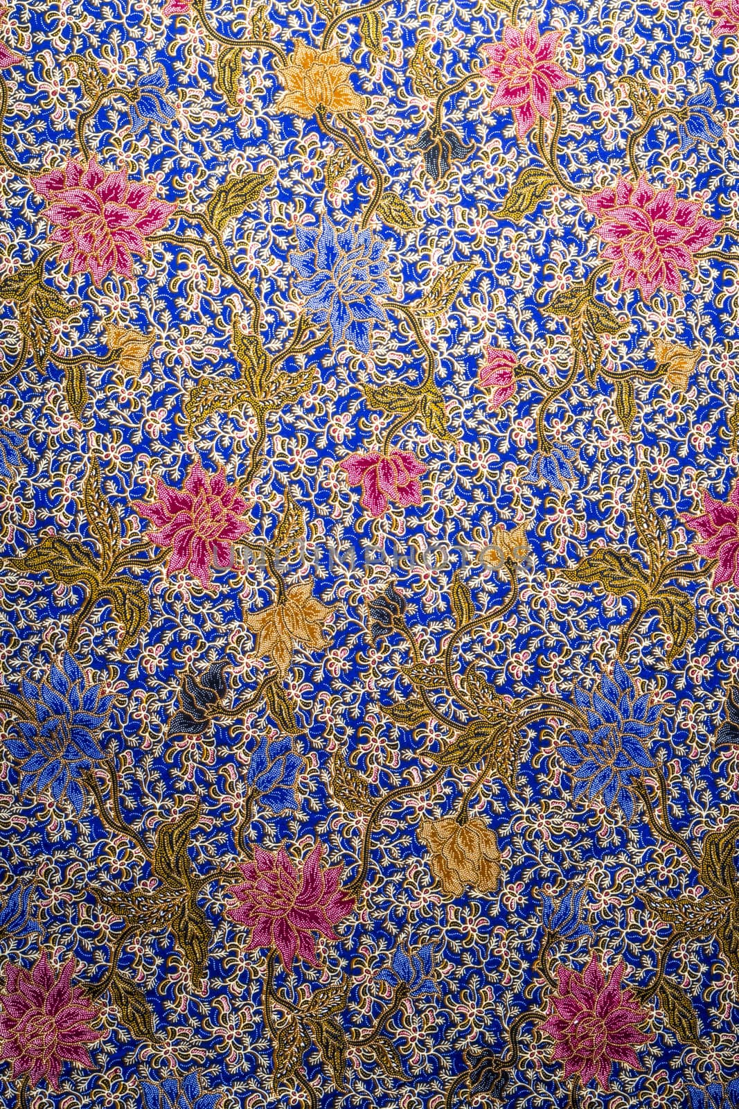 Colorful flower pattern on batik fabric bacground