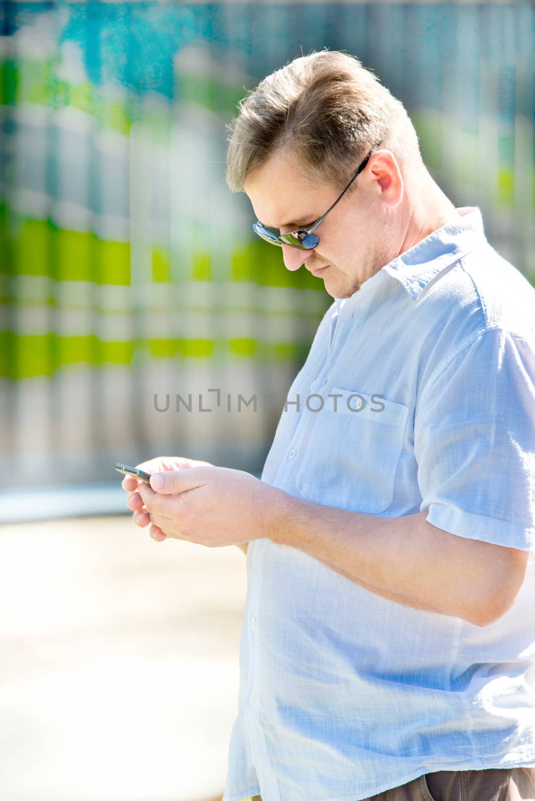 Portrait of middle-aged man with smartphone